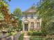 Charming two-story brick home featuring a manicured front yard, decorative door, and wrought iron details at 3663 Brookhaven Manor Crossing Ne, Atlanta, GA 30319