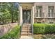 Grand front entrance featuring brick steps, columns, wrought-iron doors, and manicured hedges at 3663 Brookhaven Manor Crossing Ne, Atlanta, GA 30319