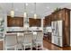 Modern kitchen featuring custom cabinetry, granite countertops, stainless steel appliances, and pendant lighting at 3663 Brookhaven Manor Crossing Ne, Atlanta, GA 30319
