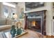 Cozy living room with a decorative fireplace and mantle, a comfortable sofa, and natural light at 3663 Brookhaven Manor Crossing Ne, Atlanta, GA 30319