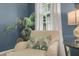 Living room nook featuring a cozy chair, accent pillow, palm tree, and natural light at 3663 Brookhaven Manor Crossing Ne, Atlanta, GA 30319