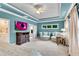 Spacious main bedroom with tray ceiling, seating area and a TV above a beautiful dark wood dresser at 3663 Brookhaven Manor Crossing Ne, Atlanta, GA 30319