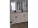 Bathroom with double vanity with matching mirrors and black fixtures at 5502 Lakeview Parkway, Villa Rica, GA 30180