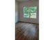Sun-filled bedroom with wooden floors and a large window at 5502 Lakeview Parkway, Villa Rica, GA 30180