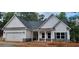 Charming single-Gathering home with stone accents, covered porch, attached garage, and a well-manicured lawn at 5502 Lakeview Parkway, Villa Rica, GA 30180