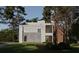 Stunning contemporary home featuring a mix of brick, wood, and light stucco facade surrounded by mature trees at 680 Carriage Dr, Atlanta, GA 30328