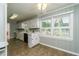 Cozy eat-in kitchen features white cabinets, a window over the sink, and modern appliances at 680 Carriage Dr, Atlanta, GA 30328
