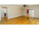 Bright living room with hardwood floors, neutral walls, and large openings that connect to other rooms at 680 Carriage Dr, Atlanta, GA 30328