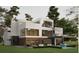 Modern home with outdoor patio, furniture, private pool, and expansive windows overlooking the landscaped backyard at 680 Carriage Dr, Atlanta, GA 30328