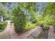 The backyard features brick paths, mature trees and a lush green lawn at 1908 E Roxboro Ne Rd, Atlanta, GA 30324