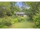 Lush backyard with mature trees and brick paths, offering a private outdoor space at 1908 E Roxboro Ne Rd, Atlanta, GA 30324