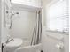 Small full bathroom features an all-white tile design and shower at 1908 E Roxboro Ne Rd, Atlanta, GA 30324
