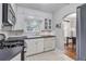 Well-lit kitchen features white cabinetry, a gas range, and stainless-steel appliances at 1908 E Roxboro Ne Rd, Atlanta, GA 30324