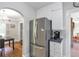 Bright kitchen with stainless steel refrigerator, a neutral color palette and hardwood floors in the adjacent room at 1908 E Roxboro Ne Rd, Atlanta, GA 30324