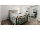 Bedroom with a decorative metal bed frame with reflective closet doors and wood vinyl flooring at 2759 Thomashire Trce, Marietta, GA 30066