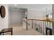 Elegant hallway with decorative iron railing, chandelier, and neutral color palette at 2759 Thomashire Trce, Marietta, GA 30066