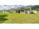 Back of the house with large lawn area and covered patio, perfect for outdoor activities at 313 Sobeck Way, Canton, GA 30115