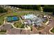 Aerial view of a community clubhouse with swimming pool, tennis courts, and manicured landscaping at 313 Sobeck Way, Canton, GA 30115