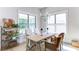 Bright dining room boasts large windows and a rustic wooden table with seating at 313 Sobeck Way, Canton, GA 30115