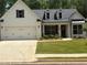 Charming white brick home with a well-manicured lawn, dormers, and an attached two-car garage at 313 Sobeck Way, Canton, GA 30115