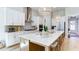 Bright kitchen features white cabinets, quartz countertops, stainless steel appliances, and a large center island at 313 Sobeck Way, Canton, GA 30115