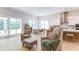 Open-concept living area with hardwood floors, modern lighting, and a view into the kitchen and patio at 313 Sobeck Way, Canton, GA 30115