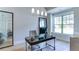 Bright office space featuring a large window, modern chandelier, and stylish decor with a large framed mirror at 313 Sobeck Way, Canton, GA 30115