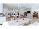Wide open concept showcasing the kitchen, dining area, and living room with stone fireplace at 313 Sobeck Way, Canton, GA 30115