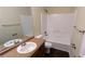 Clean bathroom featuring a vanity with a brown countertop, toilet, and tub-shower combination at 3646 Salem Dr, Lithonia, GA 30038