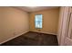 Cozy bedroom featuring neutral walls, plush carpeting, and natural light from a window at 3646 Salem Dr, Lithonia, GA 30038