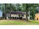 Charming single-story home with a well-maintained lawn and mature trees at 3646 Salem Dr, Lithonia, GA 30038