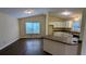 Eat-in kitchen features white cabinetry and a breakfast bar overlooking the living area at 3646 Salem Dr, Lithonia, GA 30038
