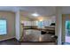 Bright kitchen with white cabinets, dark countertops, and a breakfast bar at 3646 Salem Dr, Lithonia, GA 30038