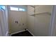 Functional laundry room space with tile floor, shelves, and hookups for washer and dryer at 3646 Salem Dr, Lithonia, GA 30038