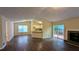 Open-concept living room with dark wood floors, a fireplace, and a view of the kitchen at 3646 Salem Dr, Lithonia, GA 30038
