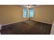 Carpeted main bedroom with two windows and a ceiling fan at 3646 Salem Dr, Lithonia, GA 30038