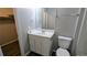 Bathroom with white vanity, toilet, and walk-in closet entrance at 1513 Foxhall Se Ln, Atlanta, GA 30316