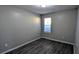 Bedroom features laminate floors, neutral paint, and a window for natural light at 1513 Foxhall Se Ln, Atlanta, GA 30316