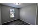 Cozy bedroom with neutral paint, laminate floors, and a window to let in light at 1513 Foxhall Se Ln, Atlanta, GA 30316