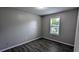 This bedroom has laminate floors, neutral paint, and a window to let in sunlight at 1513 Foxhall Se Ln, Atlanta, GA 30316