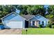 Charming one-story home with blue siding, brick accents, attached garage and well-maintained lawn at 1513 Foxhall Se Ln, Atlanta, GA 30316
