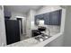 Modern kitchen with granite countertops, stainless steel appliances, and gray cabinetry at 1513 Foxhall Se Ln, Atlanta, GA 30316