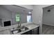 Galley kitchen featuring stainless steel sink, faucet, stainless dishwasher and view into living area at 1513 Foxhall Se Ln, Atlanta, GA 30316