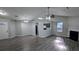 Spacious living room with hardwood floors, fireplace, modern lighting, and open kitchen view at 1513 Foxhall Se Ln, Atlanta, GA 30316