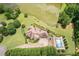 Beautiful aerial view of the property featuring a pristine pool, lush landscaping, and a serene private lake at 317 Red Gate Overlook, Canton, GA 30115