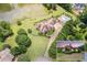 Aerial view showcasing a house with a private pool, lush landscaping, and serene waterfront views at 317 Red Gate Overlook, Canton, GA 30115