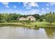 Stunning aerial view of the home nestled on a sprawling lot with a private lake and manicured landscaping at 317 Red Gate Overlook, Canton, GA 30115