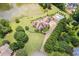 Aerial view of home with pool, lush landscaping, and serene lake highlighting the property's appeal at 317 Red Gate Overlook, Canton, GA 30115