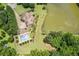 Aerial view showcasing the pool, landscaping, and private lake that enhance this home's appeal at 317 Red Gate Overlook, Canton, GA 30115