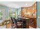Custom bar area with wood accents, shelving, and seating for entertaining at 317 Red Gate Overlook, Canton, GA 30115